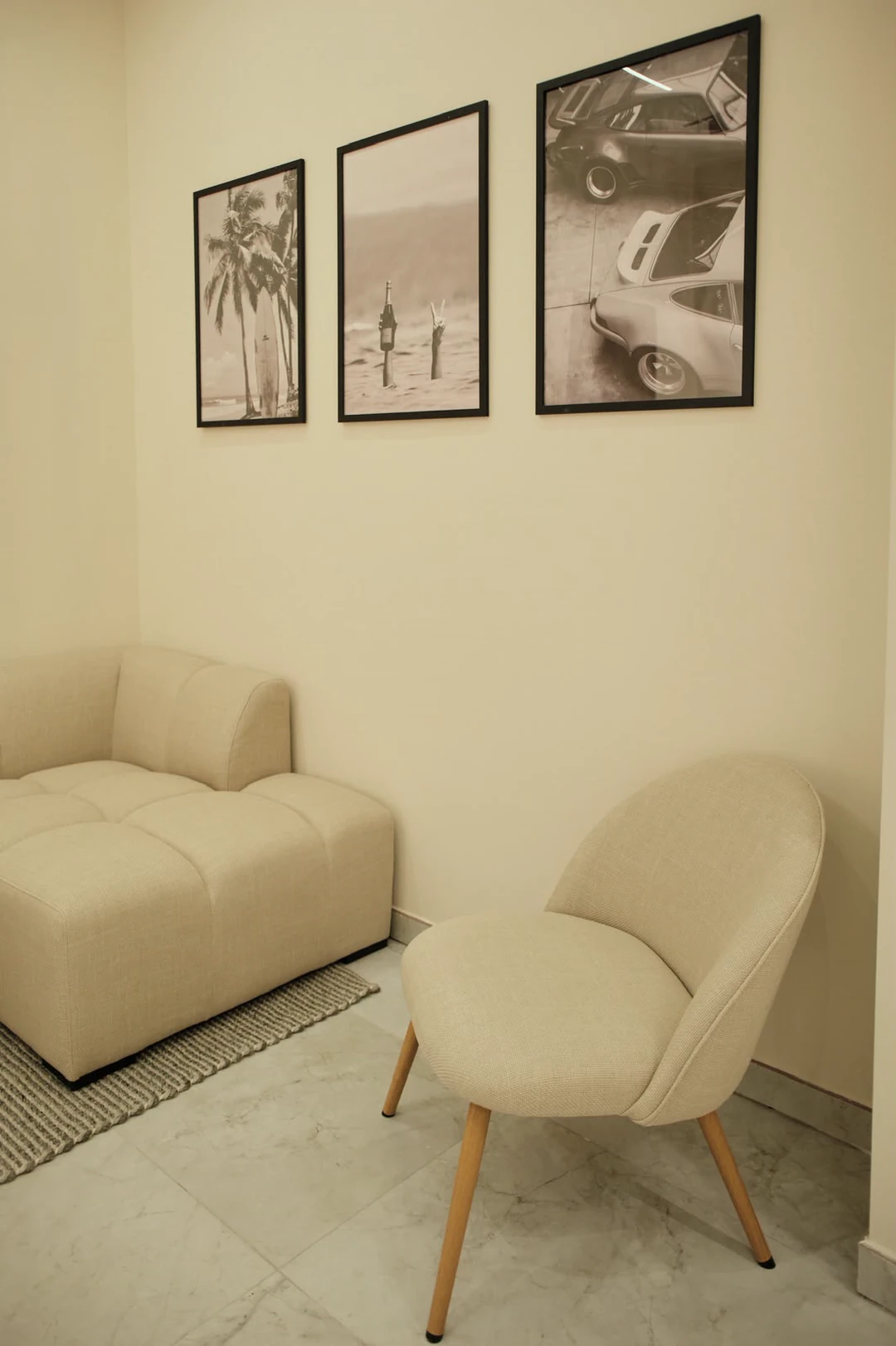 The corner armchair beside the sofa, on a travertine floor.