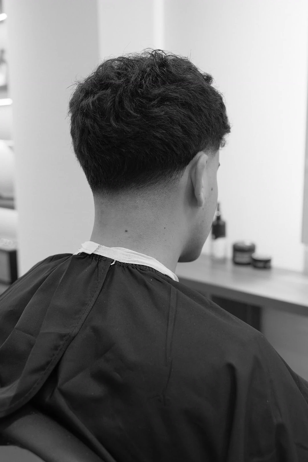A finished cut from behind, the neckline clean to the skin.