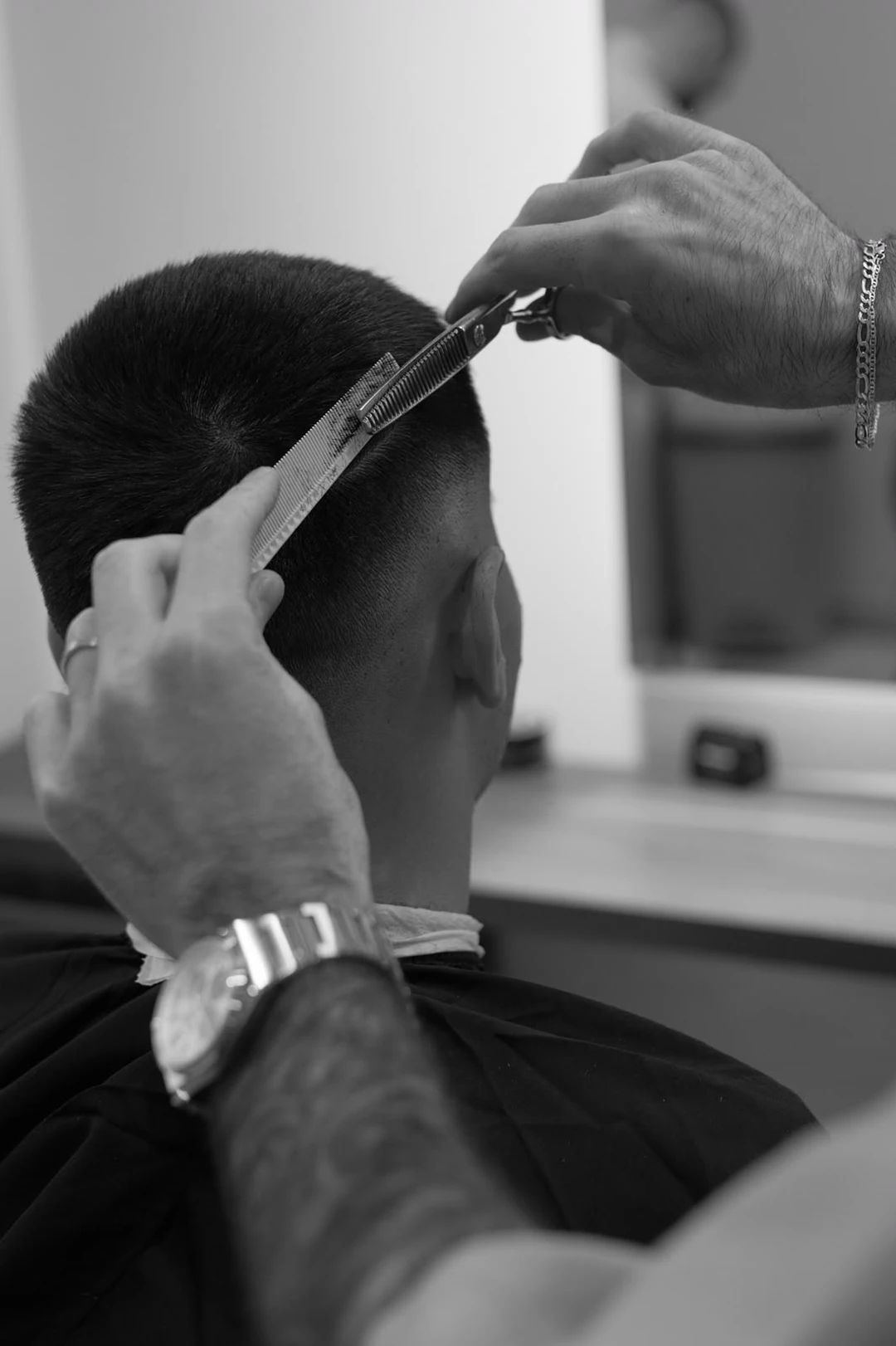 Shears and comb working through the back of a cut.